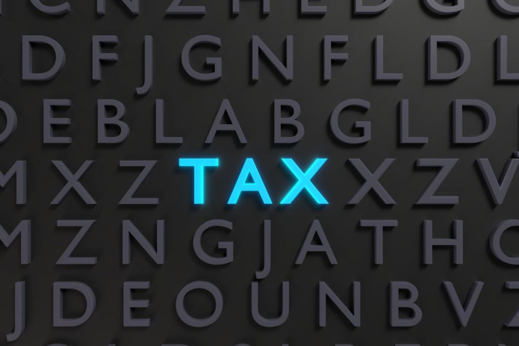 The word tax is spelled out on a black background.