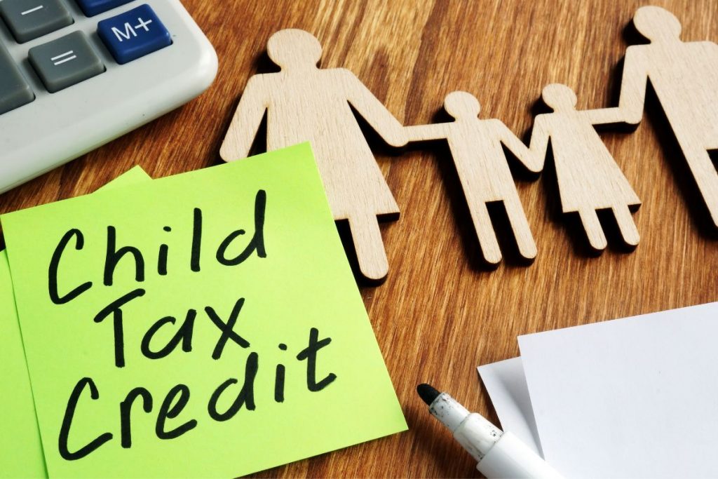 Child tax credit on a table with pens and a calculator.