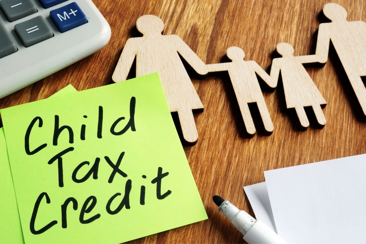 Child tax credit on a table with pens and a calculator.