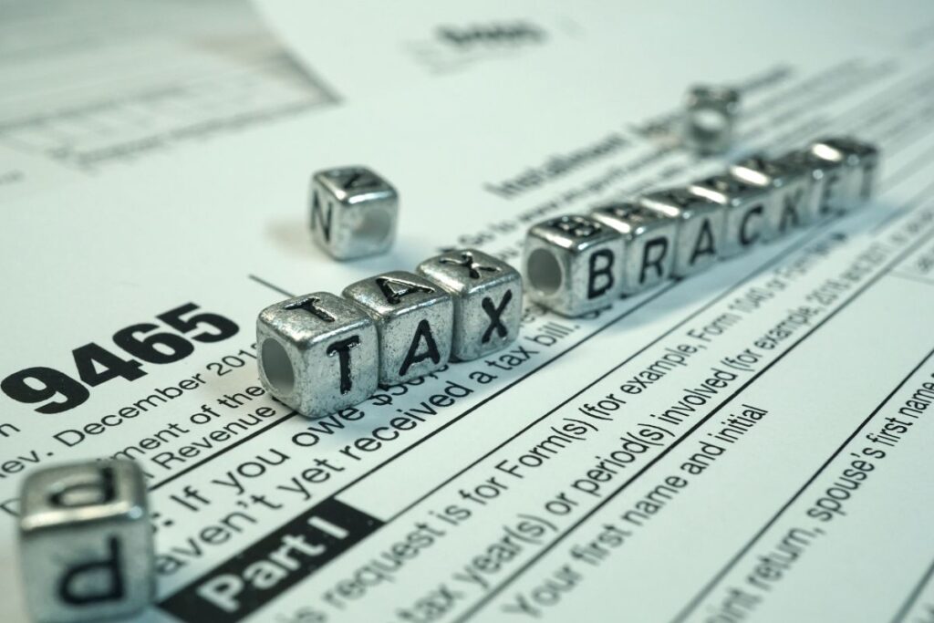 A stack of tax forms with the word 'tax break' spelled out.